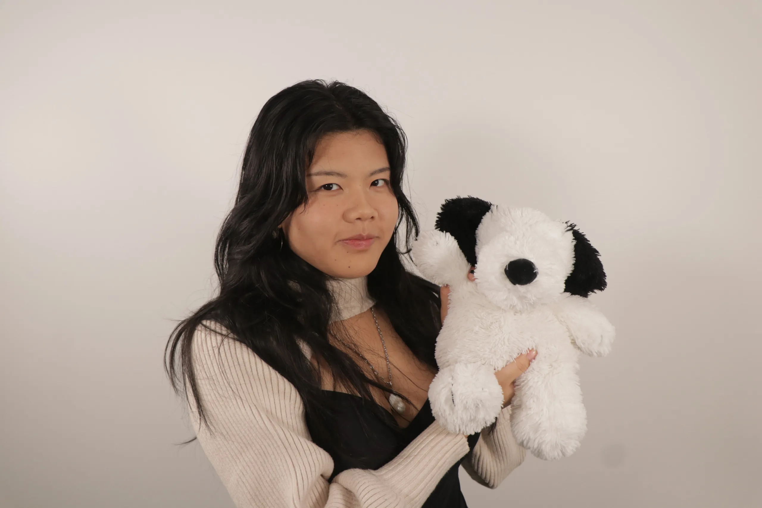 Peggy Shen holding a stuffed dog toy
