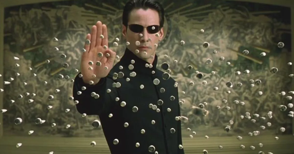 Neo stopping a hail of bullets mid-air in The Matrix (1999).